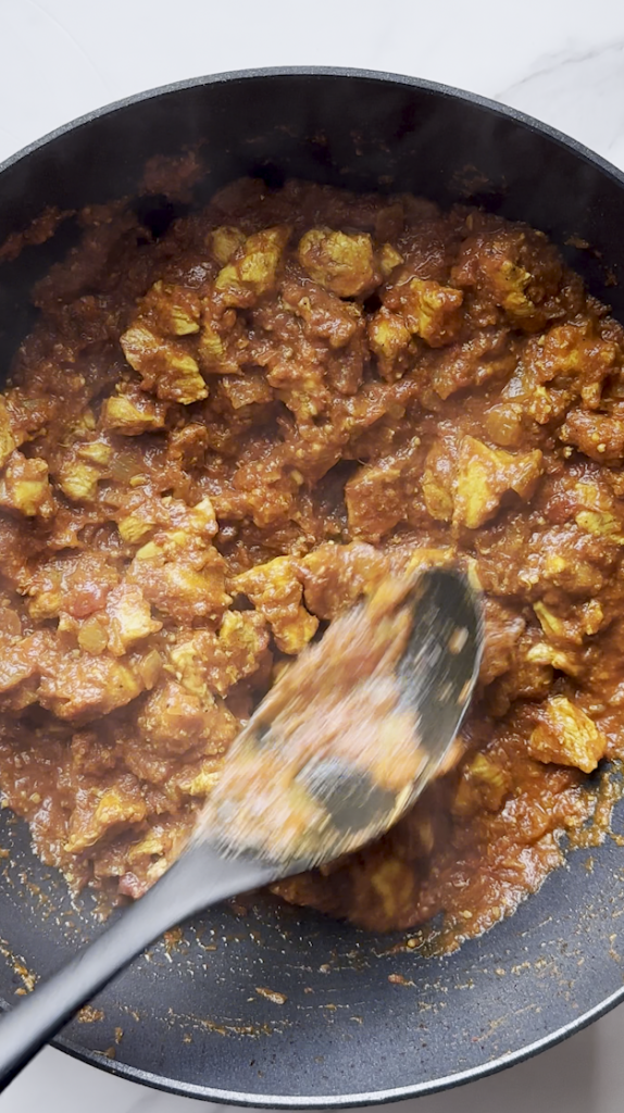 diced onions and cut up chicken and garlic with tomato sauce and fully coated